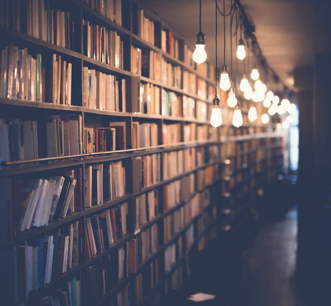 Warmly lit archive shelves holding historical records