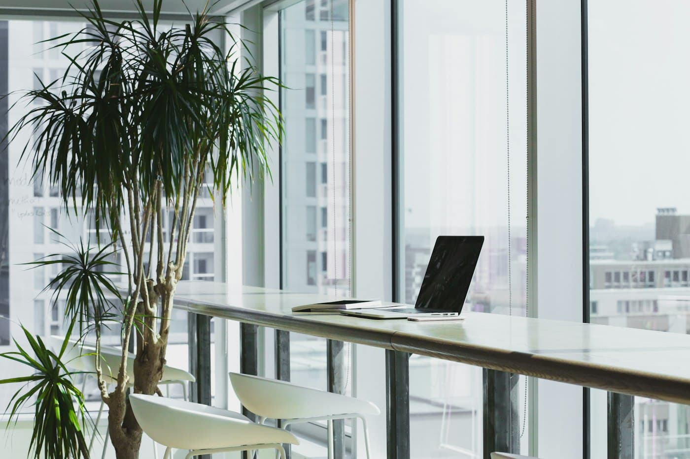 Bright office workspace beside floor to ceiling windows